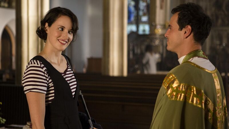 A woman talks to a young priest in this image from Two Brothers Pictures.
