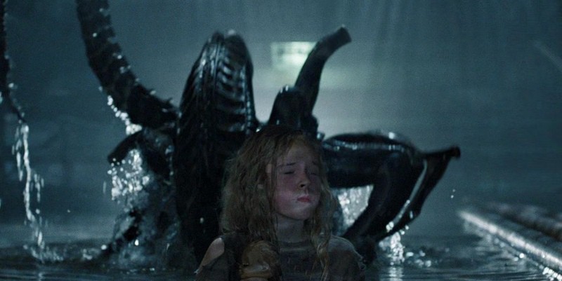 An alien emerges from the water behind a young girl in this image from Brandywine Productions.
