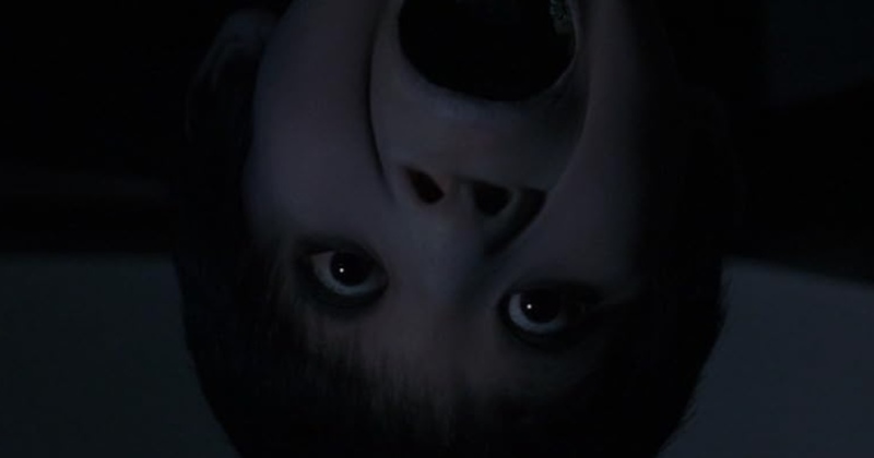 A ghostly young boy appearing upside down screams in this image from Columbia Pictures.
