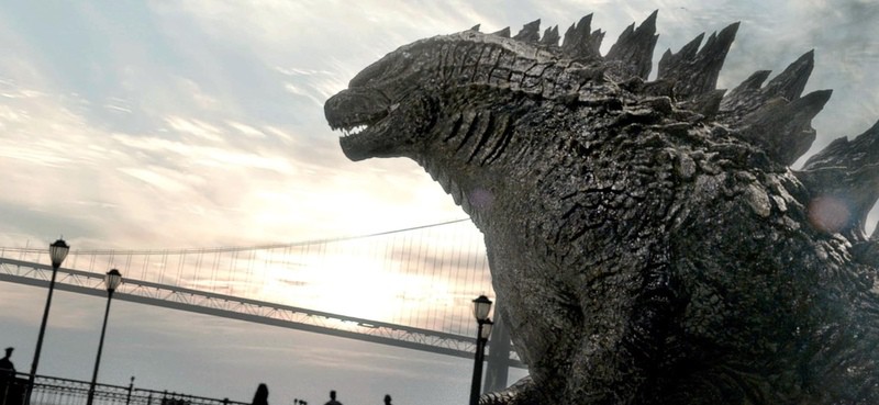 A gigantic lizard walks by a bridge in this image from Legendary Pictures.