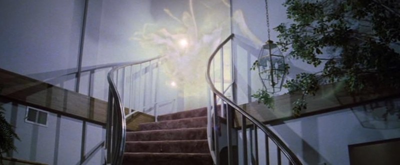 An apparition made of lights floats above a staircase in this image from Metro-Goldwyn-Mayer.