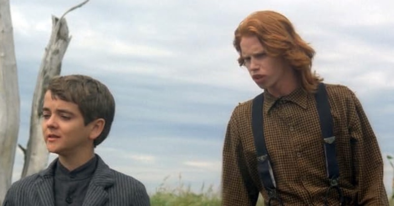 Two boys in rural attire stand in a cornfield in this image from Angeles Entertainment Group.