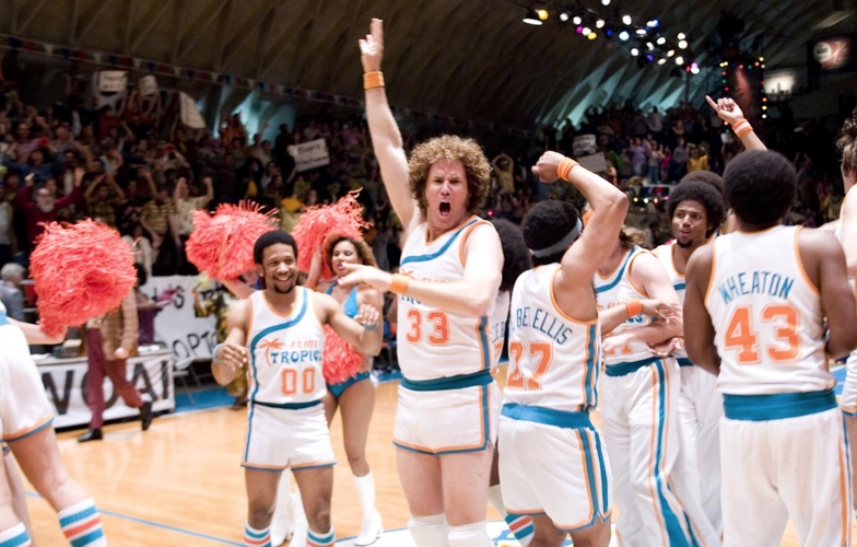 A basketball team celebrates on the court in this image from Mosaic Media Group.