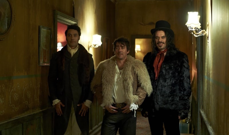 Three well-dressed vampires stand in a hallway in this image from Resnick Interactive.