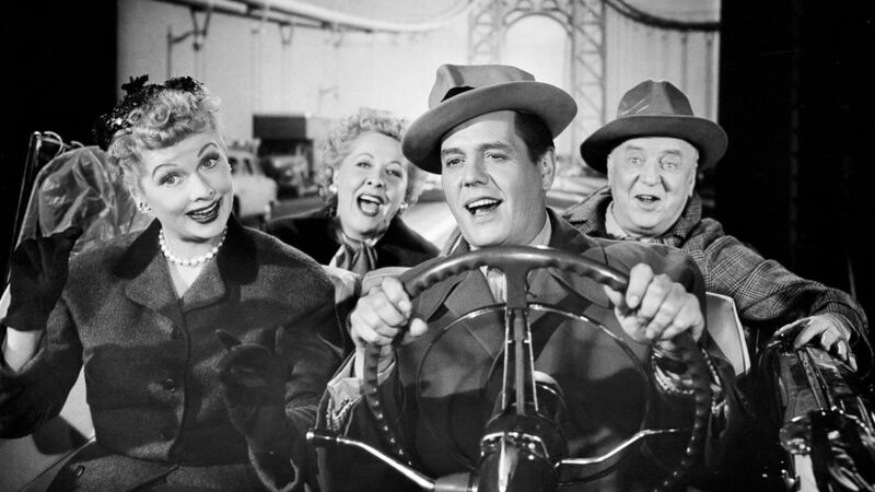 Two couples taking a drive in a car in this image from Desilu Productions.