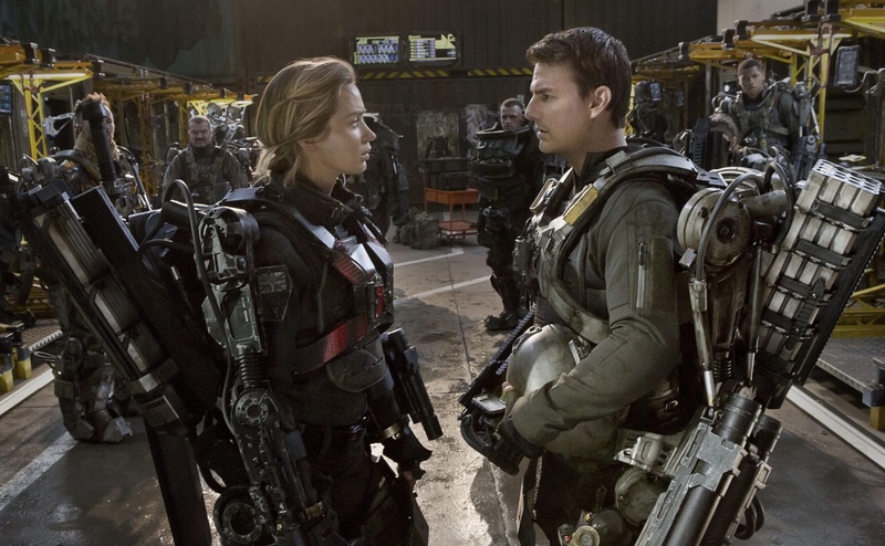 Two soldiers converse while wearing battle mechs in this image from Village Roadshow Pictures.