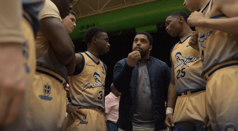 A basketball coach talks to his players during a game in this image from Undisputed Cinema.