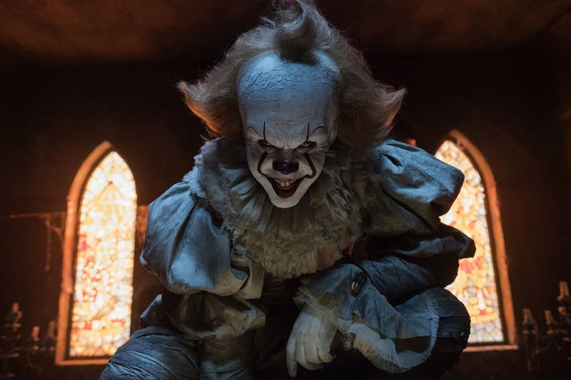 An evil clown in a church in this image from New Line Cinema