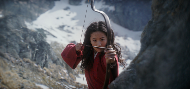 A young woman shoots an arrow in the mountains in this image from Walt Disney Pictures.