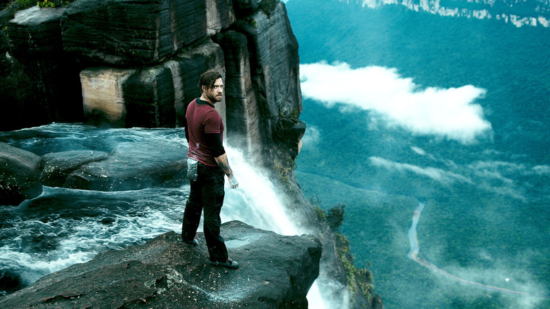 A man looks back from the edge of a waterfall in this image from Alcon Entertainment.