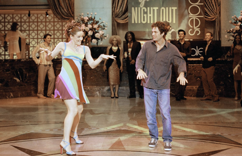 A man and woman dance on a dance floor in this image from Revolution Studios.