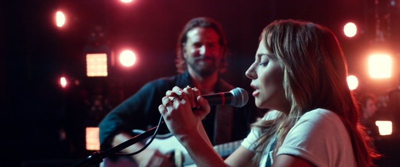 A woman sings and a man plays guitar in this image from Metro-Goldwyn-Mayer.