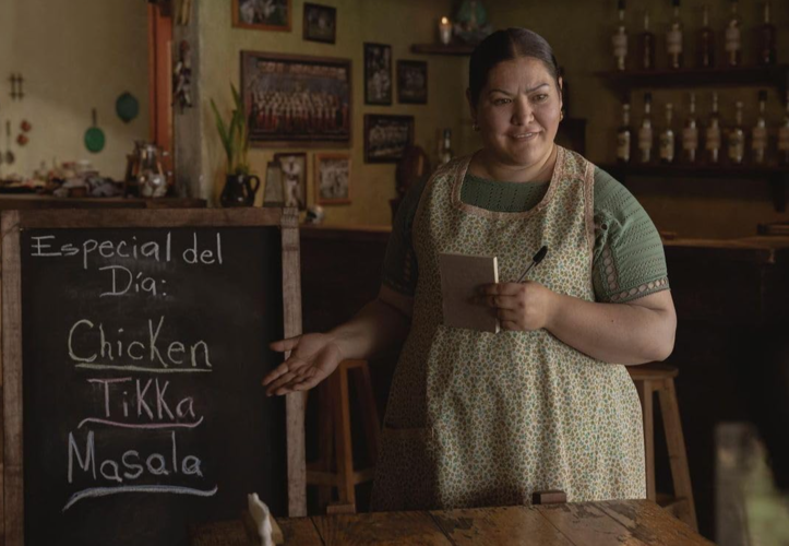 A waitress points to a menu in this image from Pimienta Films.