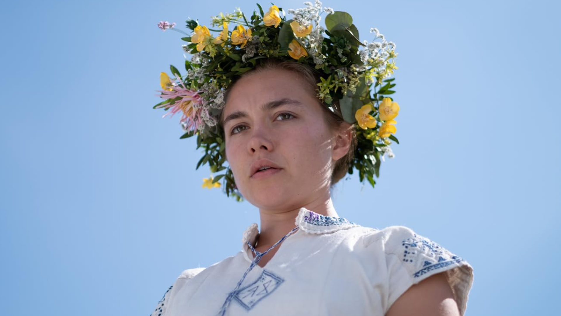 A young woman wears a flower crown in this image from A24.