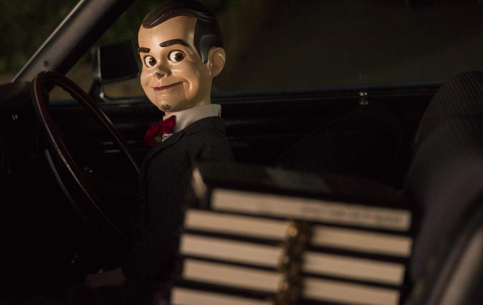 A ventriloquist dummy sits behind the wheel of a car in this image from Columbia Pictures.