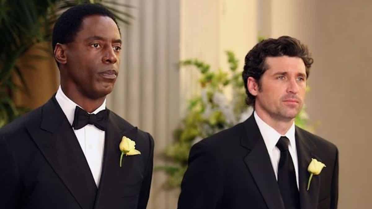 Two men in tuxedos stand next to each other in a church in this image from Shondaland.