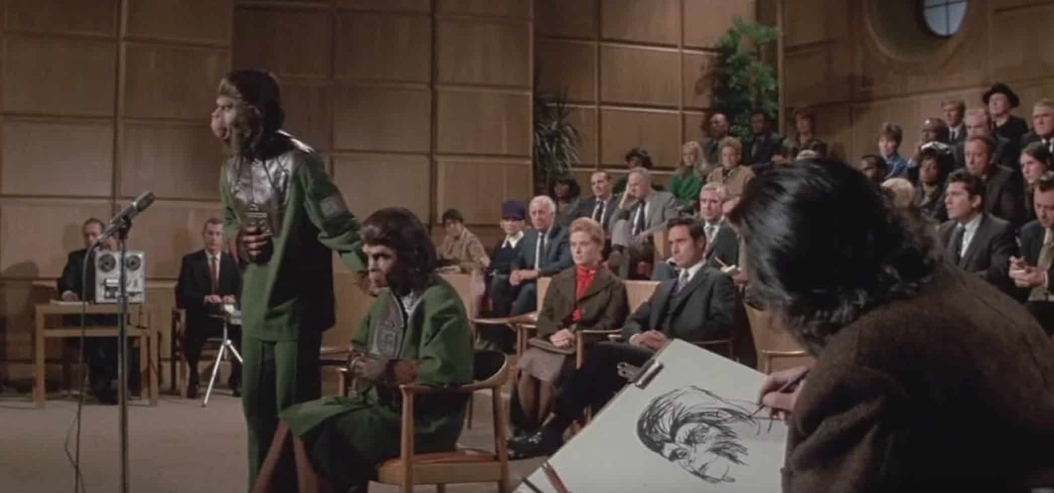 Two apes speak in a courtroom in this image from APJAC Productions.