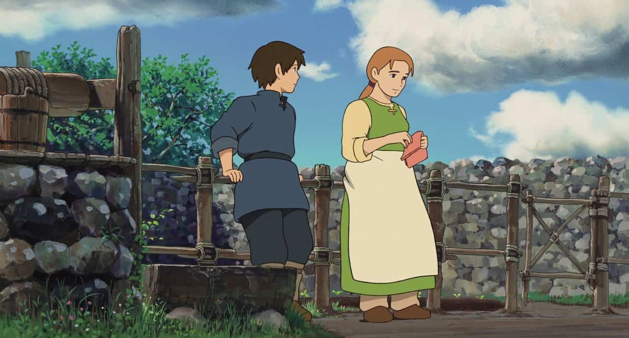 An animated boy and girl leaning on a fence in this image from Studio Ghibli.
