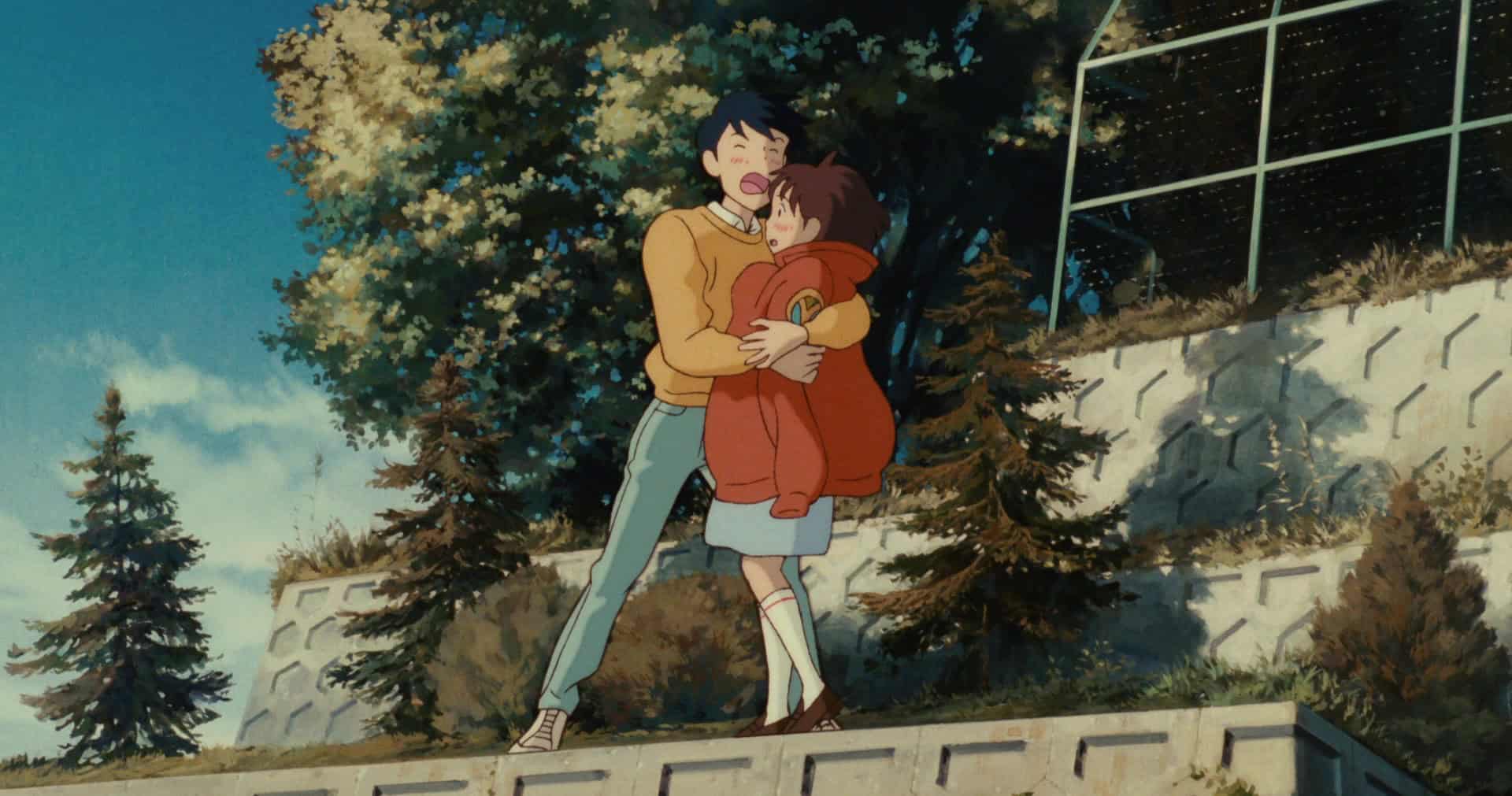An animated boy yells into the wind while holding a girl in this image from Studio Ghibli.