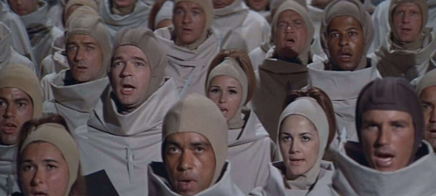 A group of robed humans gather in this image from APJAC Productions.