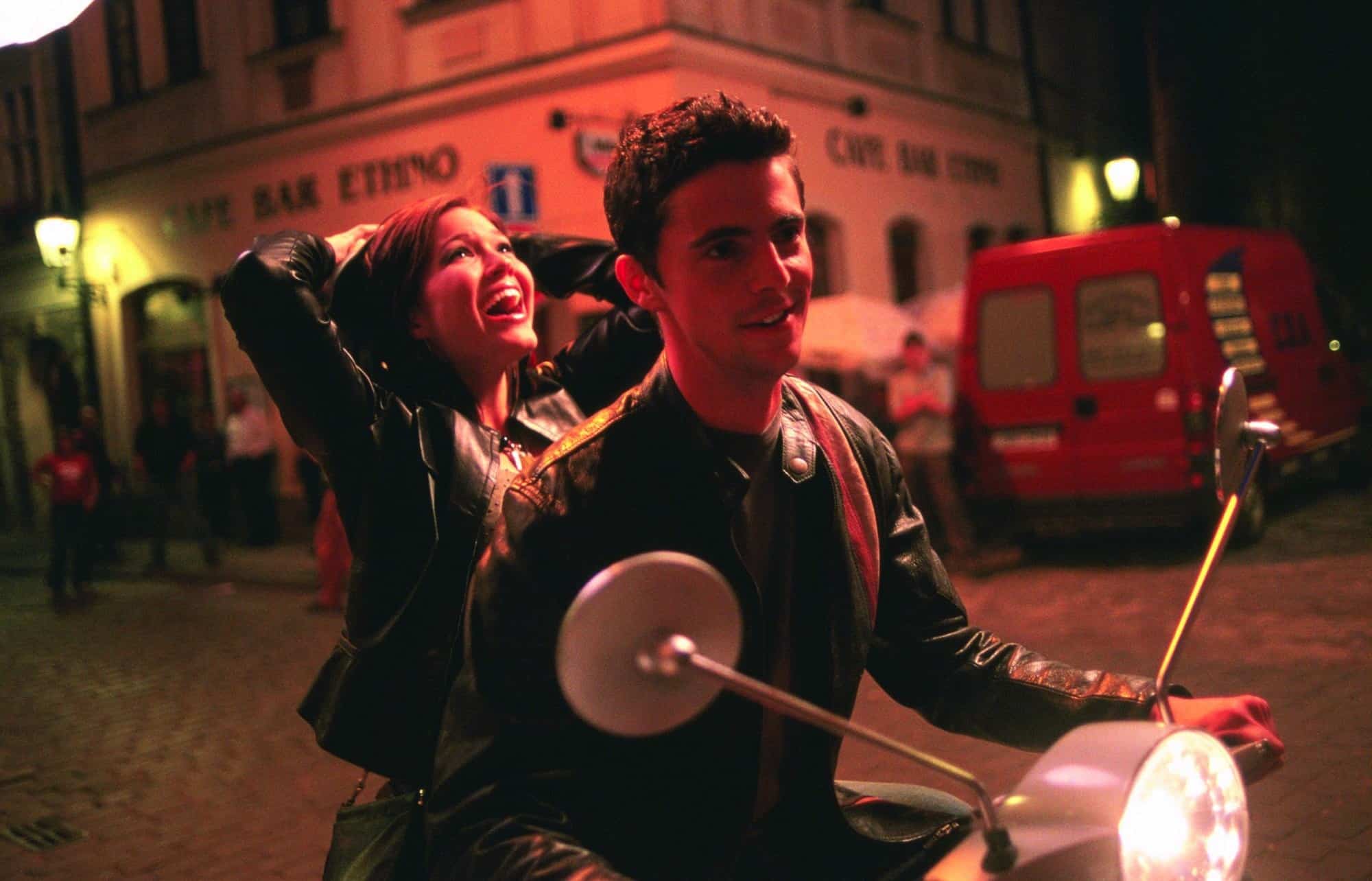 A woman yells out in joy on the back of a man’s motorcycle in this image from Alcon Entertainment.