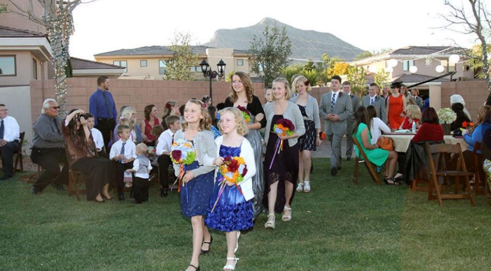 Children holding bouquets walk in a procession in this image from Figure 8 Films.