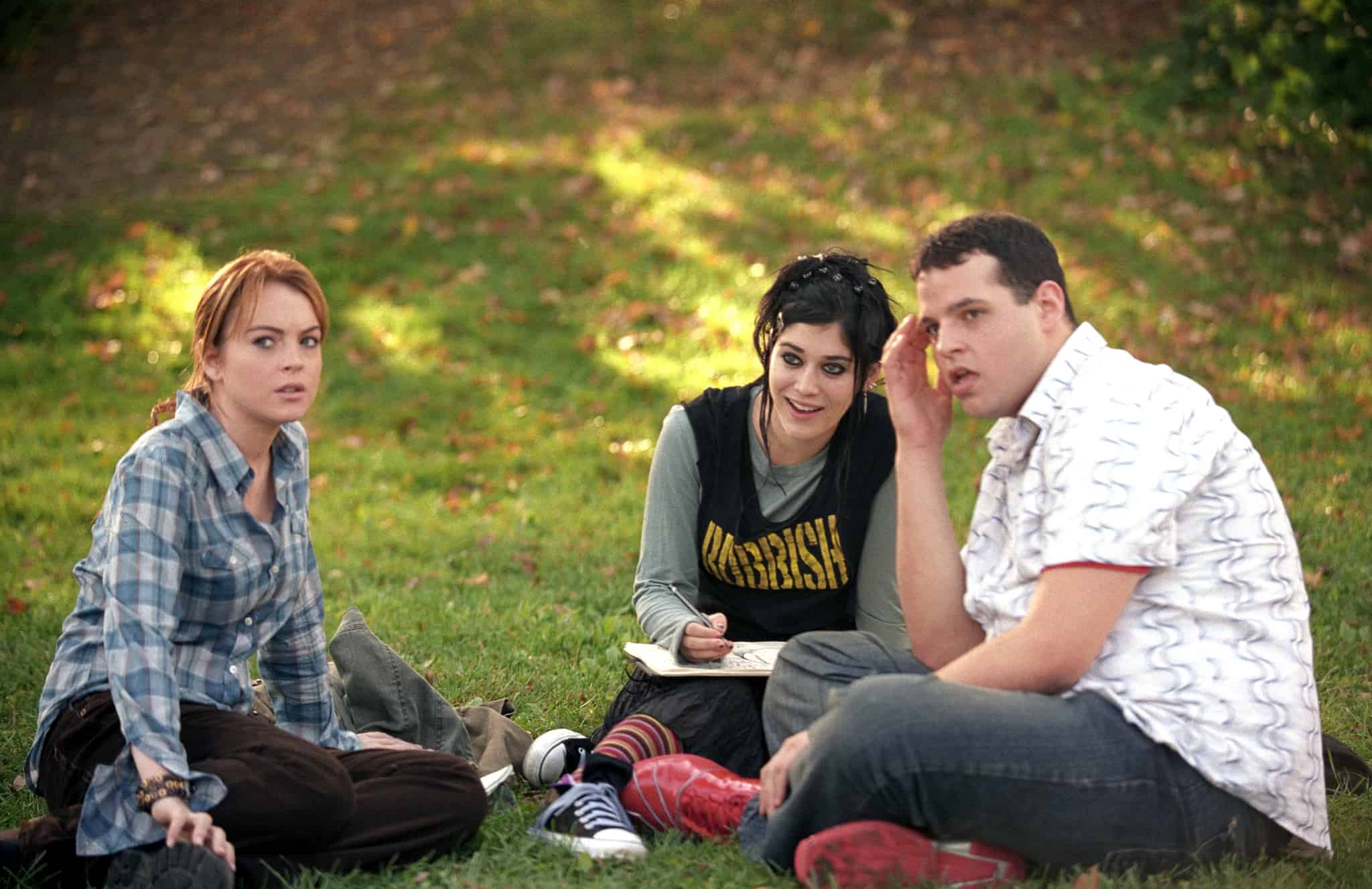 Three students sit in the grass in this image from Paramount Pictures.
