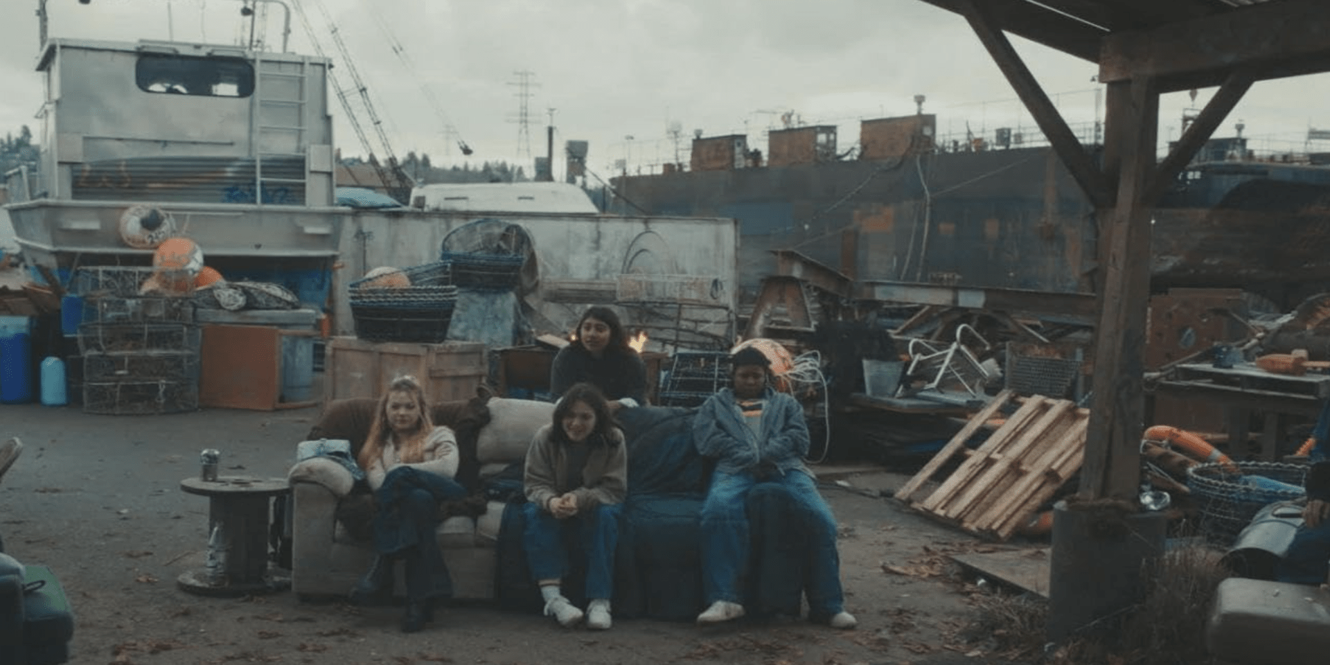 Four teenage girls sitting on a couch in a junkyard in this image from ABC Signature.